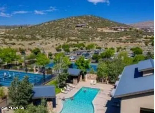 a front view of a house with large trees