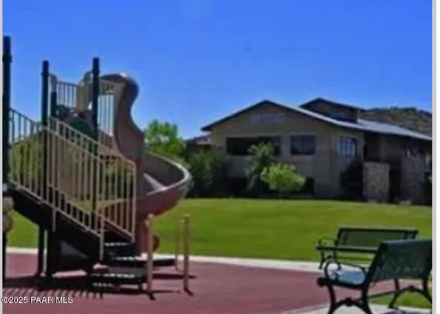 a view of a yard with an outdoor seating a yard and mountain view in back