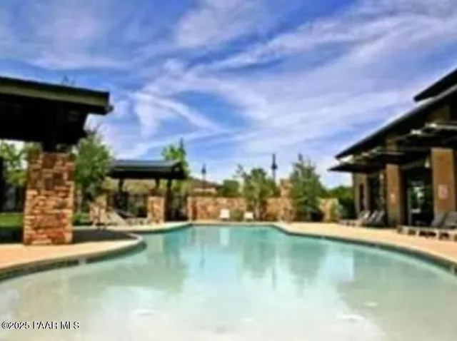 a view of a chair and table in the backyard