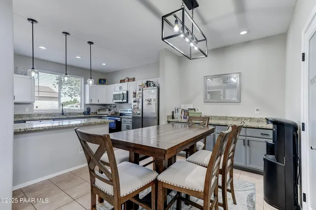 a kitchen with a dining table and chairs