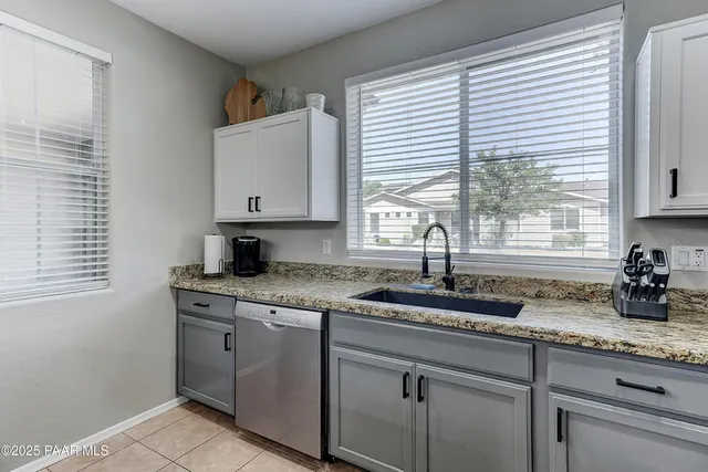 a dining room with stainless steel appliances kitchen island a table and chairs