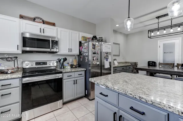a kitchen with granite countertop a sink and a window