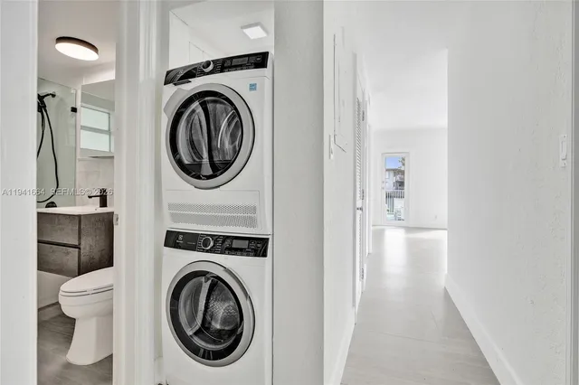 a view of a hallway with washer and dryer