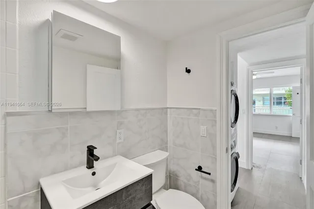 a bathroom with a toilet sink and shower