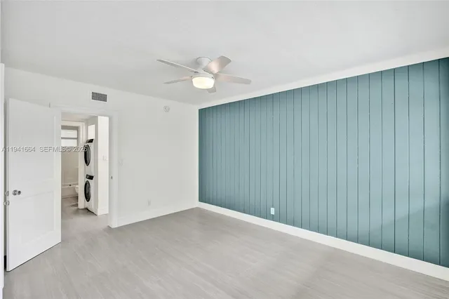 a view of an empty room with closet area