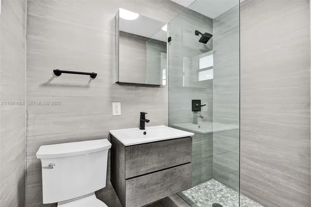 a bathroom with a sink toilet and mirror