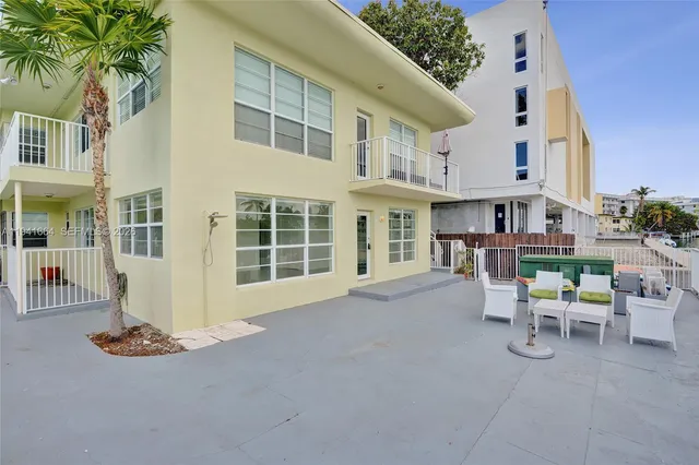 a view of a house with backyard porch and sitting area