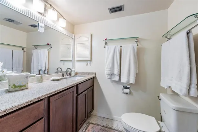 a white toilet sitting next to a bathroom sink