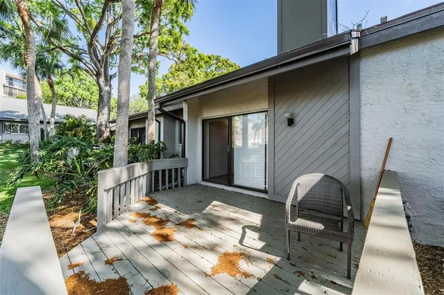 a backyard of a house with table and chairs