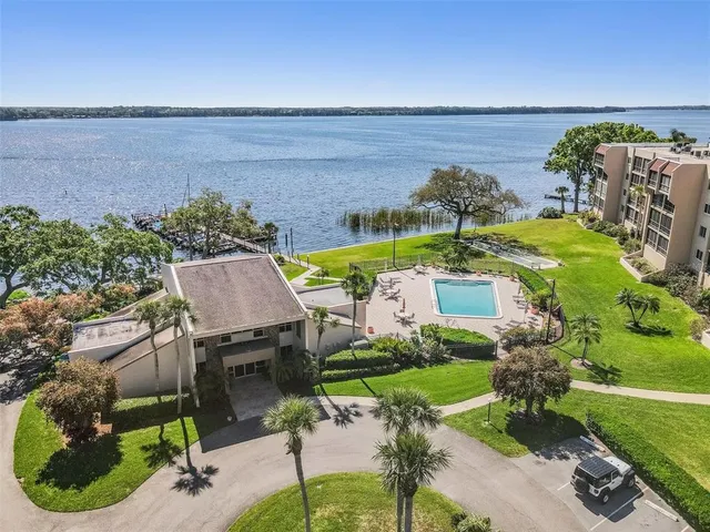 an aerial view of residential building with outdoor space and river