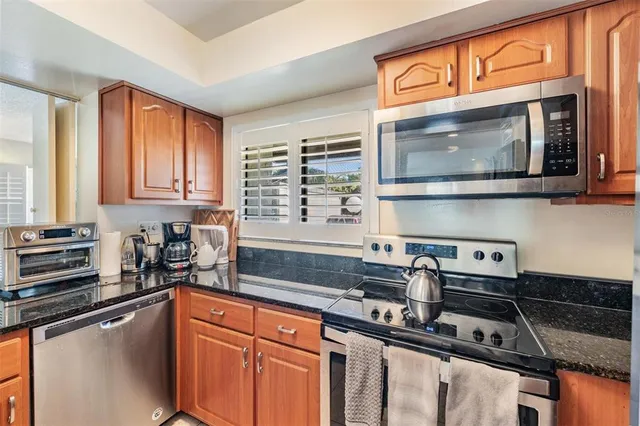 a kitchen with a sink cabinets and window