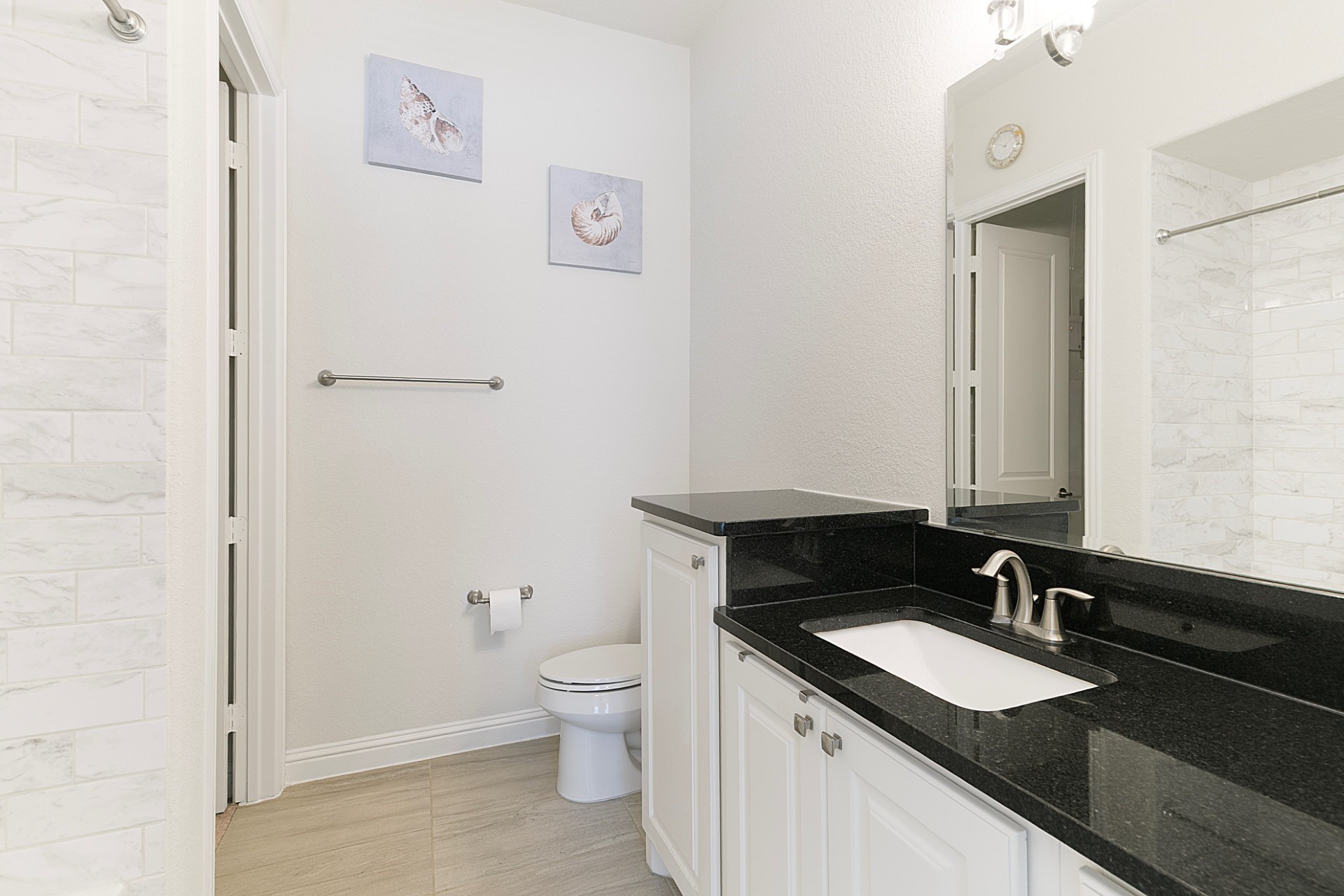 1415 Maple Stream Drive Houston, TX 77043 - Photo 19 of 29 a bathroom with a granite countertop sink and a mirror
