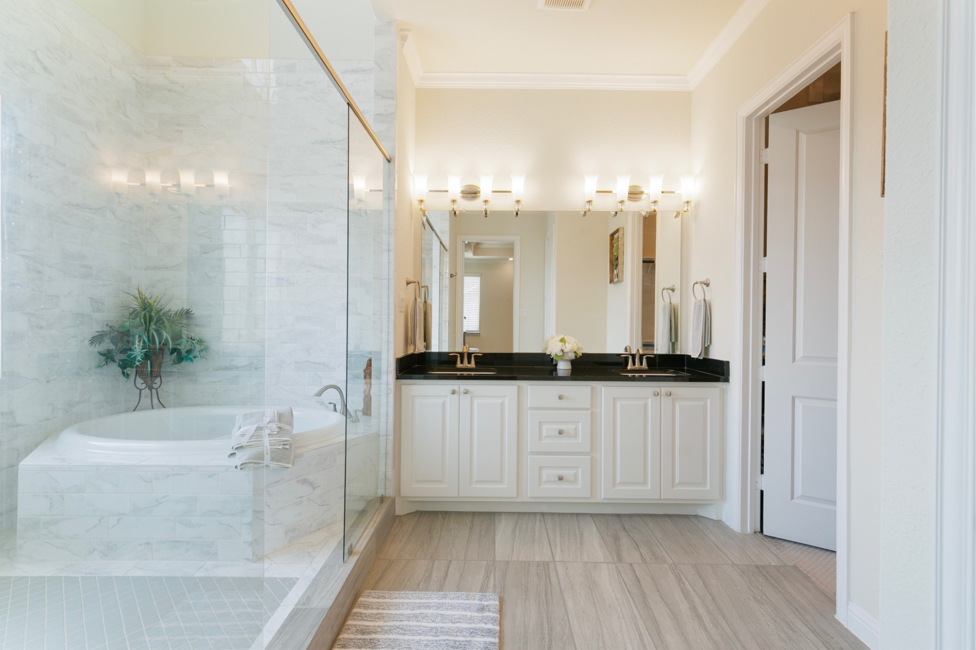 1415 Maple Stream Drive Houston, TX 77043 - Photo 22 of 29 a bathroom with a granite countertop sink a mirror and a bathtub