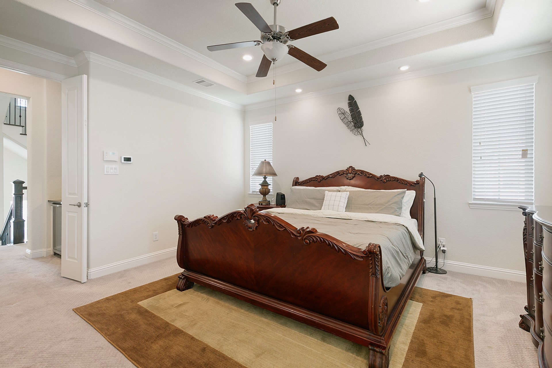 1415 Maple Stream Drive Houston, TX 77043 - Photo 23 of 29 a bedroom with a bed and a ceiling fan