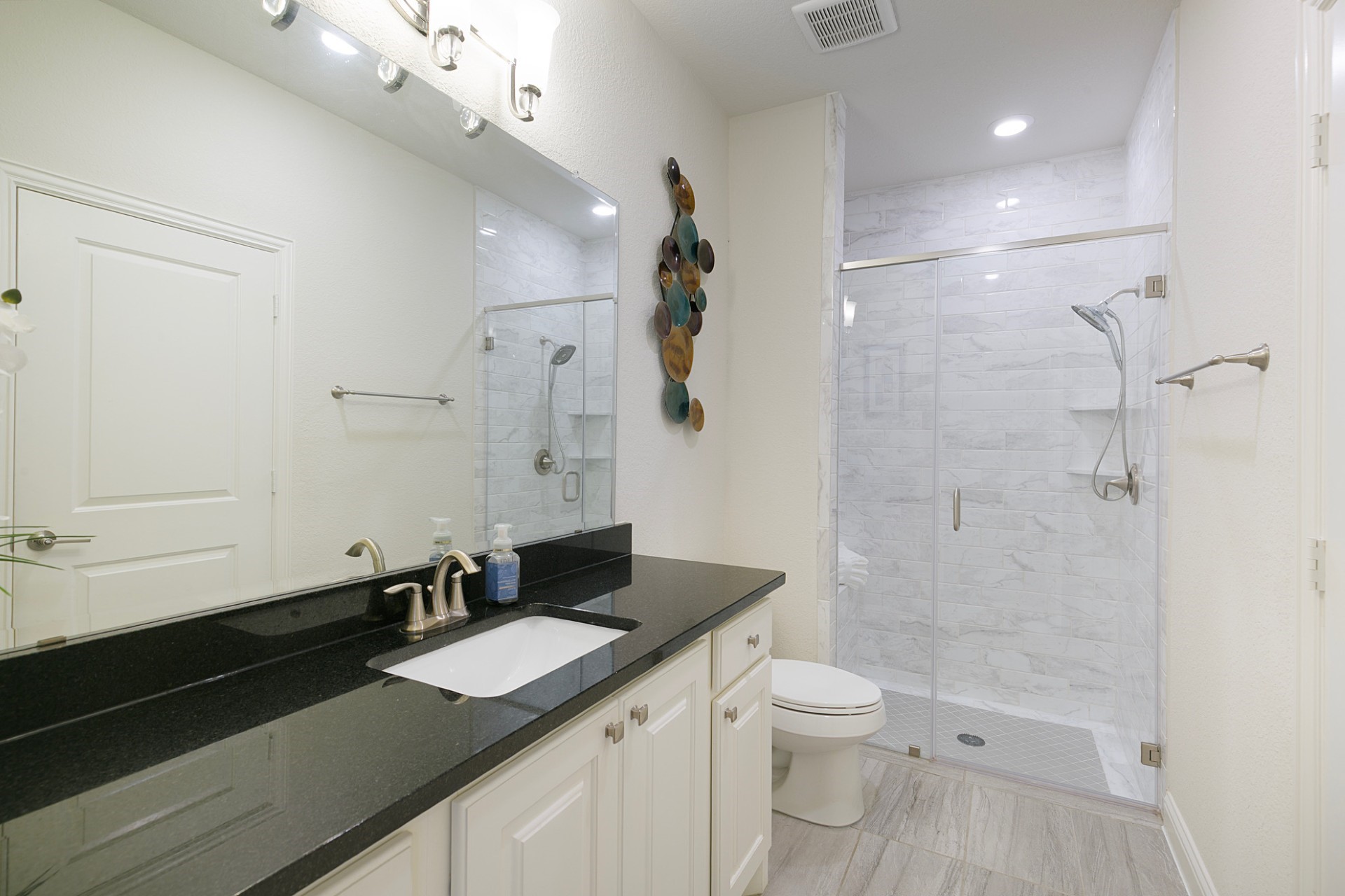 1415 Maple Stream Drive Houston, TX 77043 - Photo 5 of 29 a bathroom with a granite countertop sink a toilet a mirror and shower