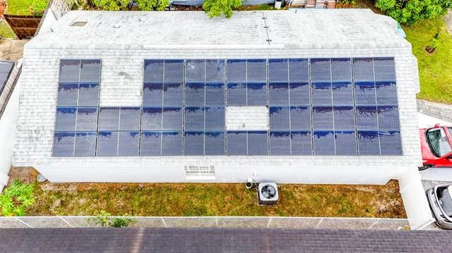 a aerial view of a residential apartment building with a yard