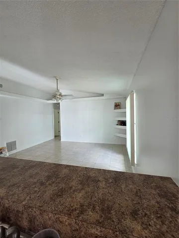 an empty room with a empty space and windows