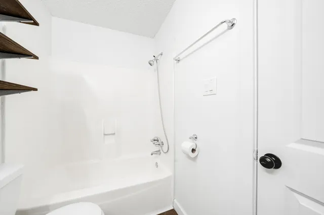 a bathroom with a bathtub and shower