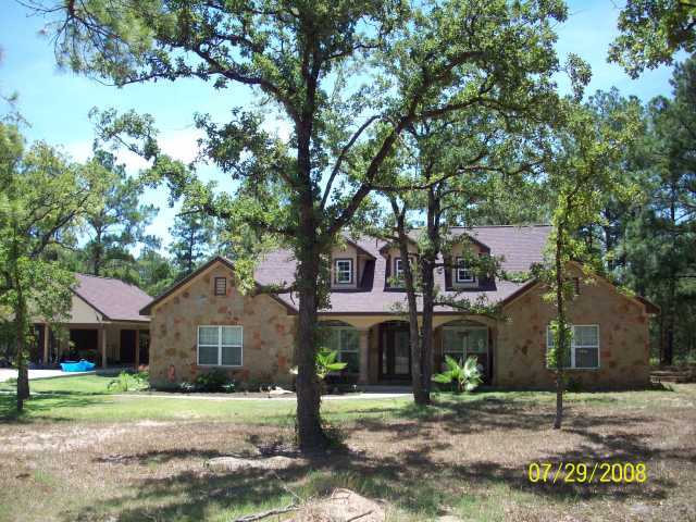 335 Hoffman Road Bastrop, TX 78602 - Photo 1 of 1 a front view of a house with a yard