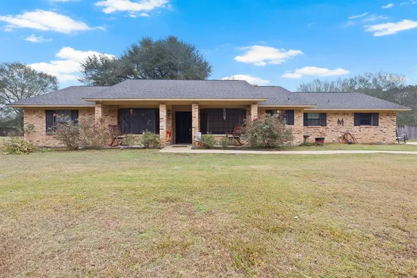 a front view of house with yard outdoor seating and barbeque oven