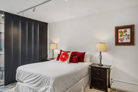 a bedroom with a bed and a lamp