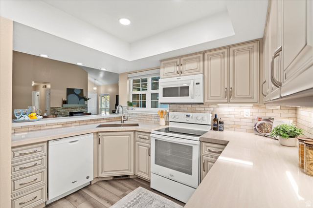 Well-appointed kitchen with generous counter space, updated finishes, and a convenient breakfast bar overlooking the main living area.
