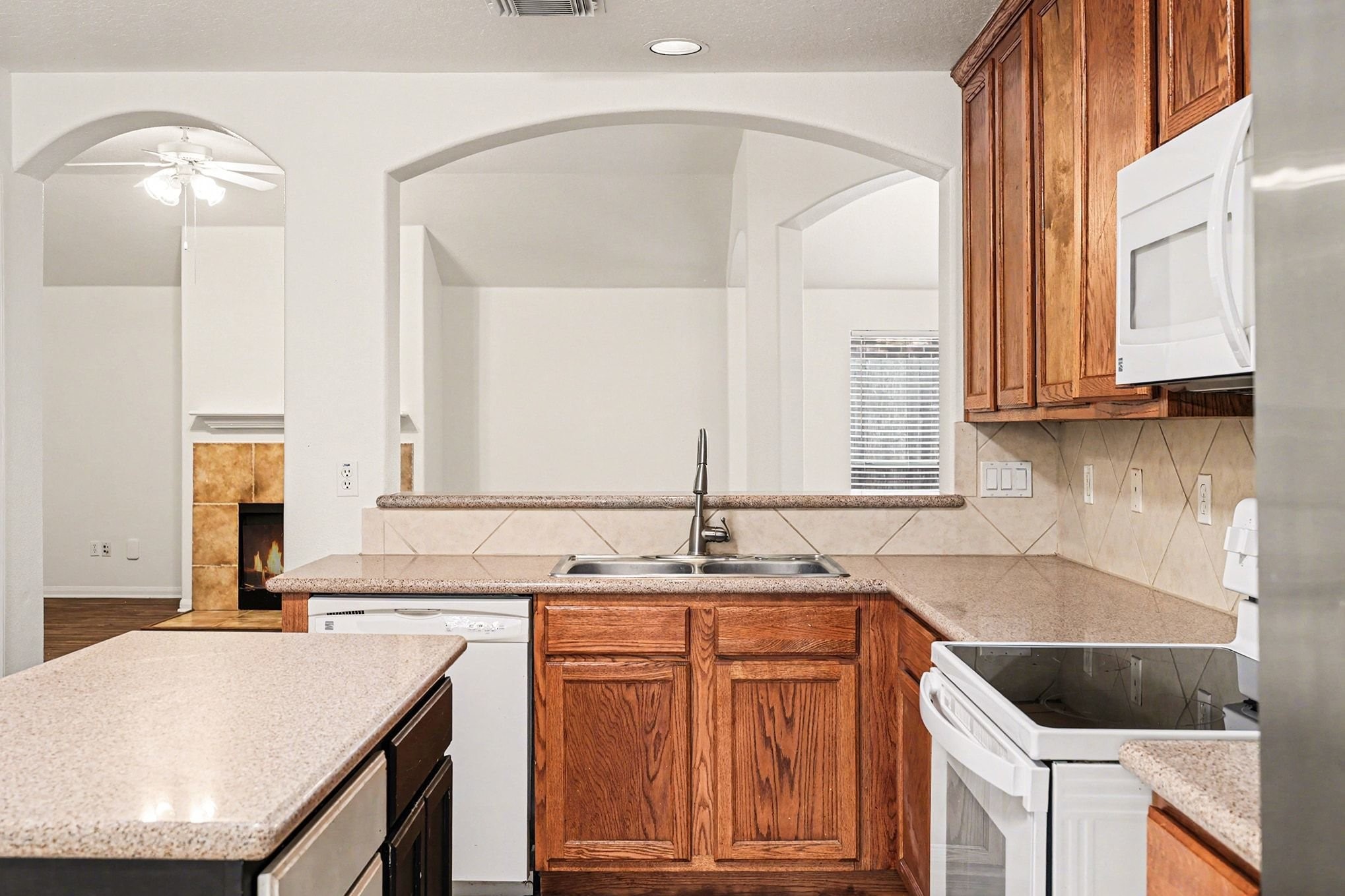3218 Woodchuck Road Montgomery, TX 77356 - Photo 14 of 27 a kitchen with stainless steel appliances granite countertop a sink stove and cabinets