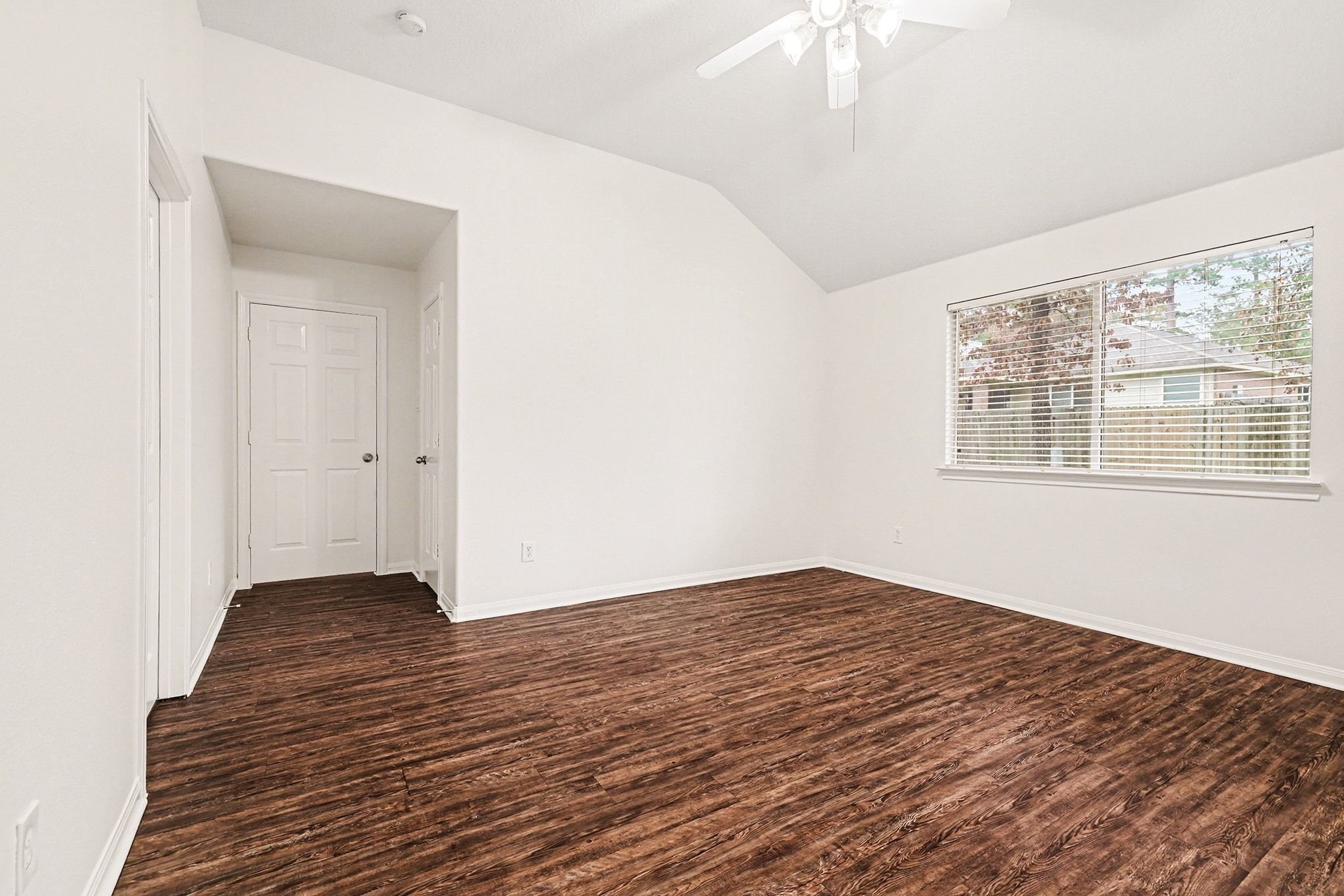 3218 Woodchuck Road Montgomery, TX 77356 - Photo 17 of 27 a view of an empty room with wooden floor and a window