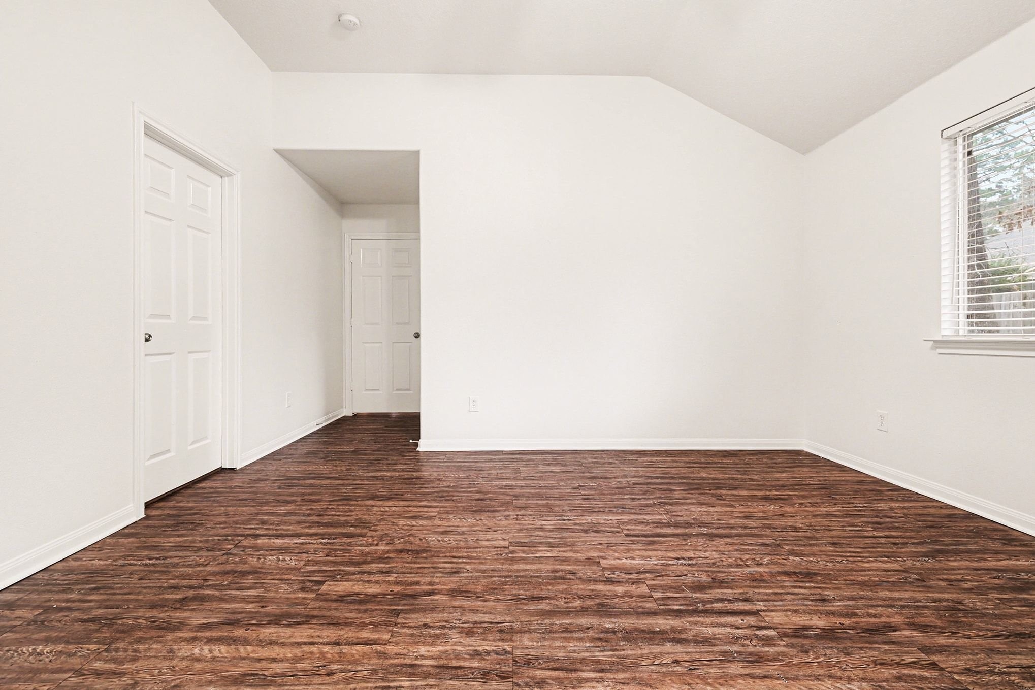 3218 Woodchuck Road Montgomery, TX 77356 - Photo 19 of 27 a view of an empty room with wooden floor and a window