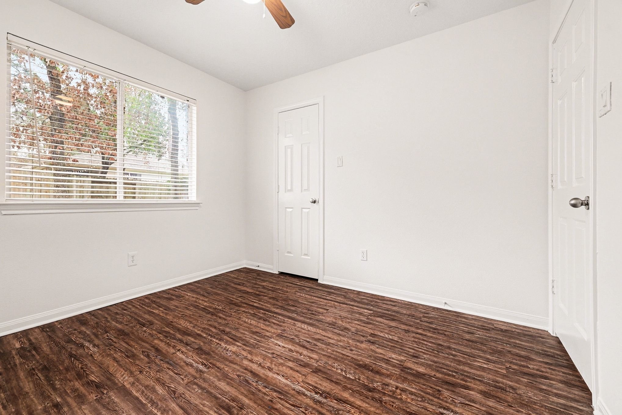 3218 Woodchuck Road Montgomery, TX 77356 - Photo 21 of 27 a view of an empty room with wooden floor and a window