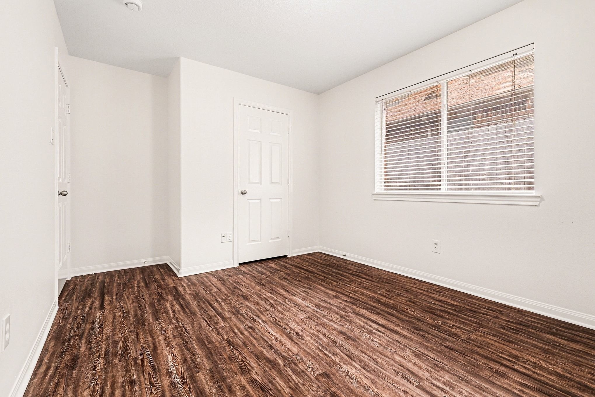 3218 Woodchuck Road Montgomery, TX 77356 - Photo 22 of 27 a view of a room with wooden floor and a window
