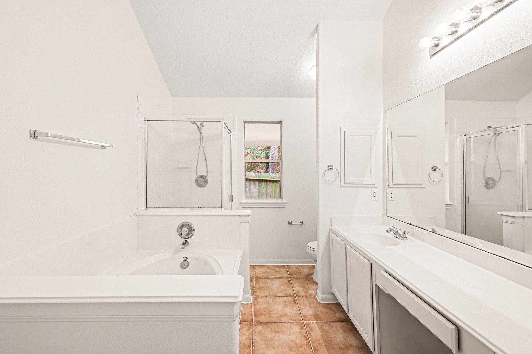 3218 Woodchuck Road Montgomery, TX 77356 - Photo 25 of 27 a bathroom with a tub sink and mirror