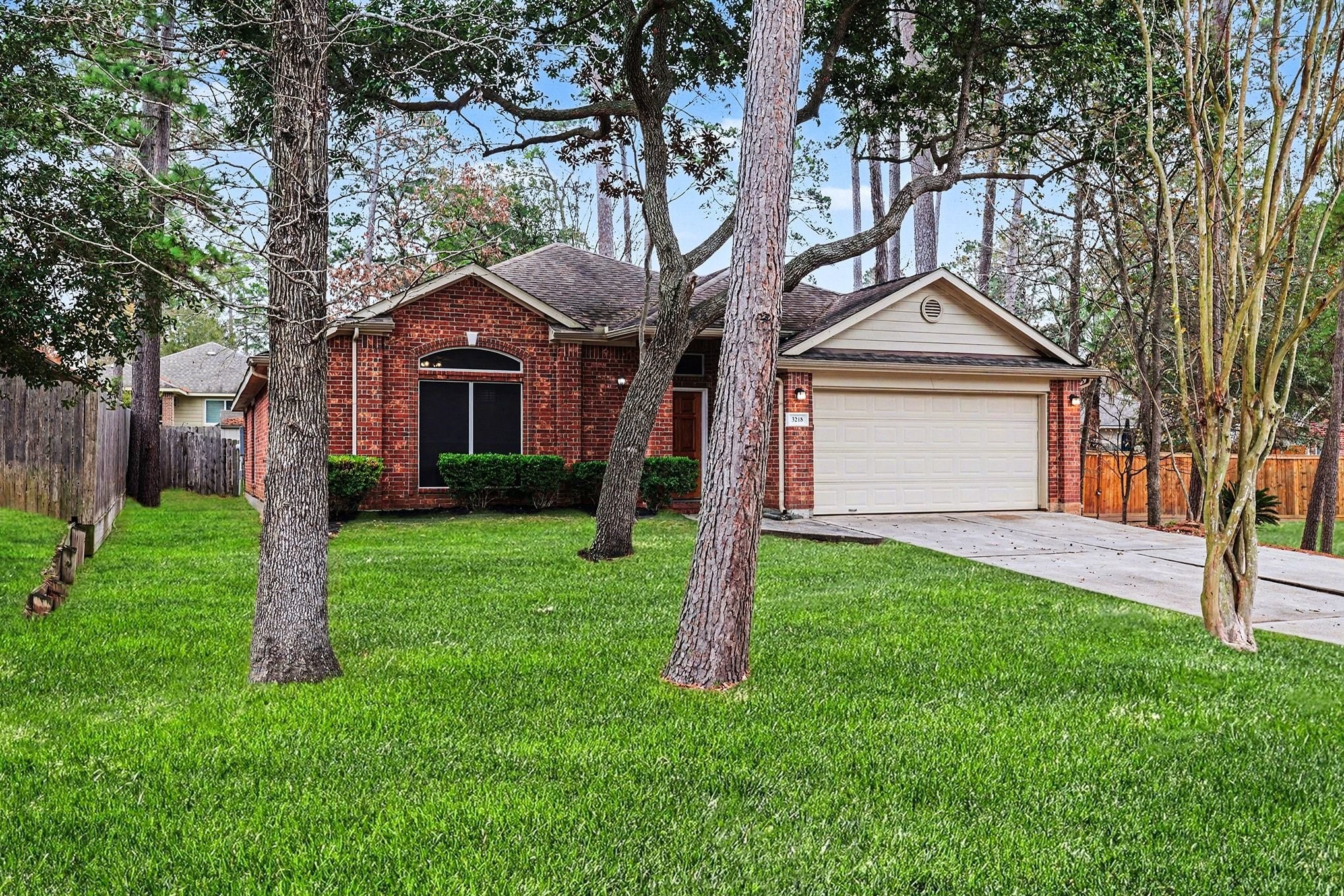 3218 Woodchuck Road Montgomery, TX 77356 - Photo 3 of 27 a front view of a house with a yard and trees
