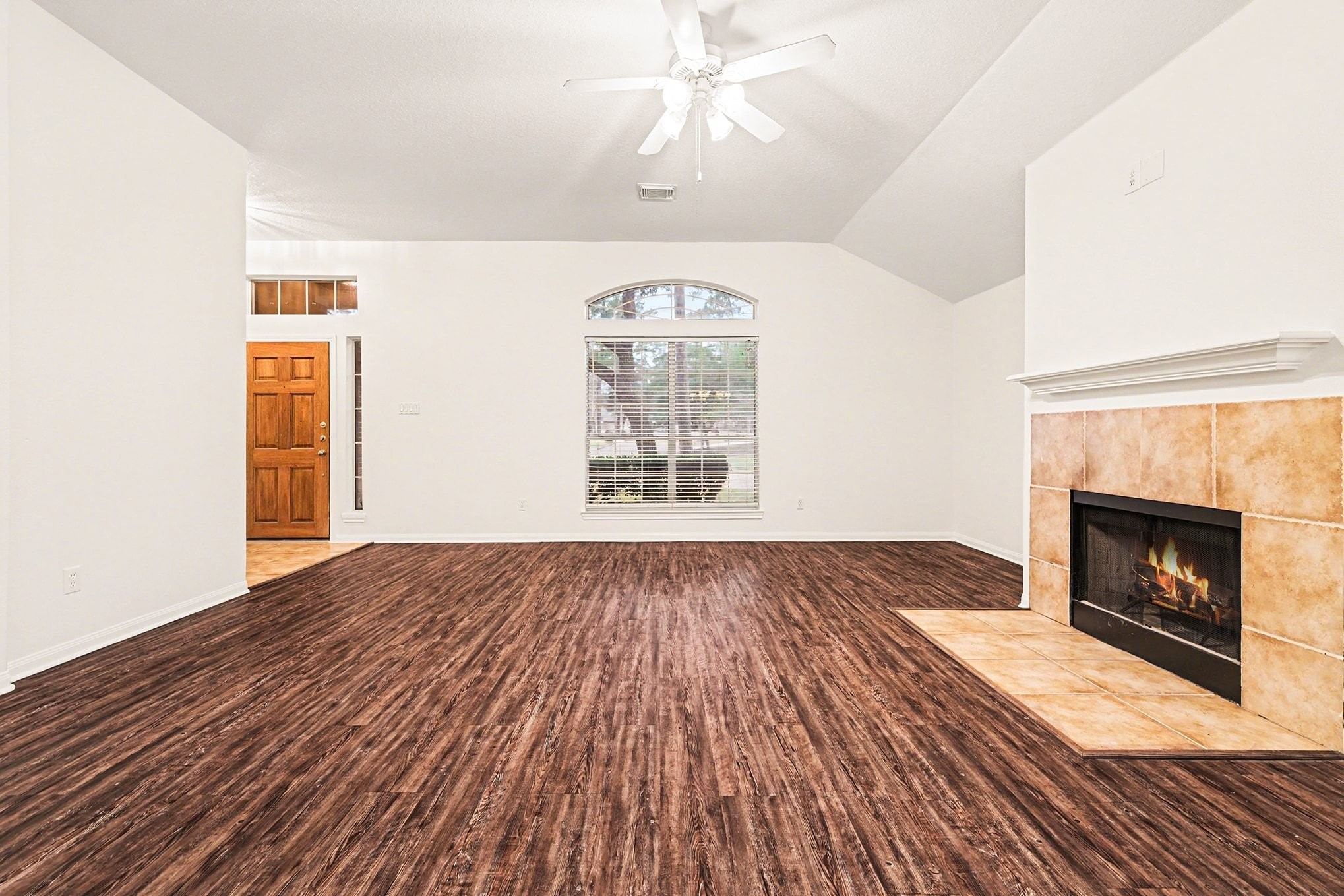 3218 Woodchuck Road Montgomery, TX 77356 - Photo 7 of 27 wooden floor fireplace and windows in an empty room