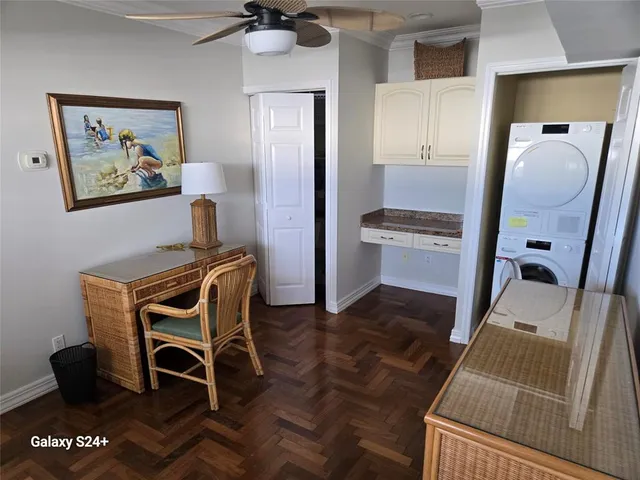 a view of a workspace with furniture and a mirror