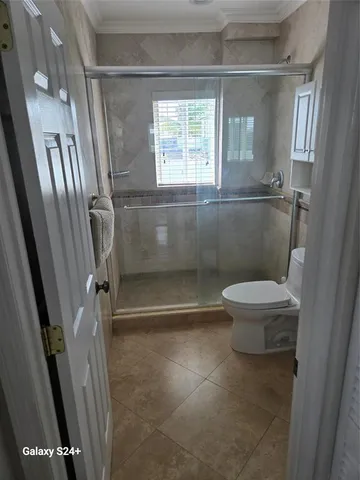 a bathroom with a toilet and a shower