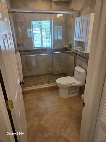 a bathroom with a toilet and a shower