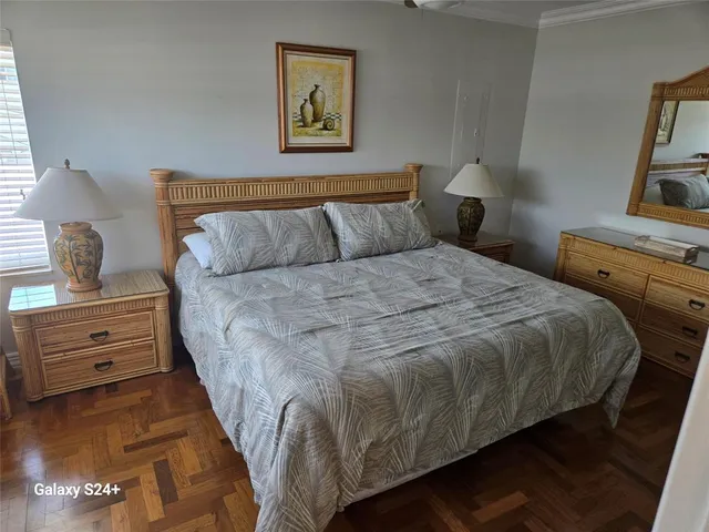 a bedroom with a bed and painting on the wall