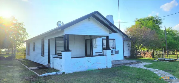 a view of a house with a yard and porch