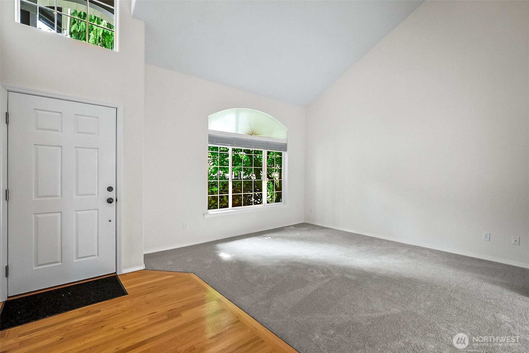 18410 11th Drive Southeast Bothell, WA 98012 - Photo 4 of 40 a view of an empty room with wooden floor and a window