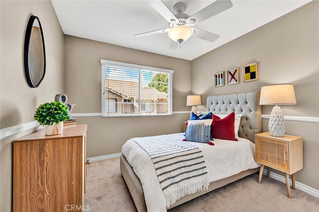 2489 Via Castillo Tustin, CA 92782 - Photo 13 of 30 a bedroom with a bed and a chandelier