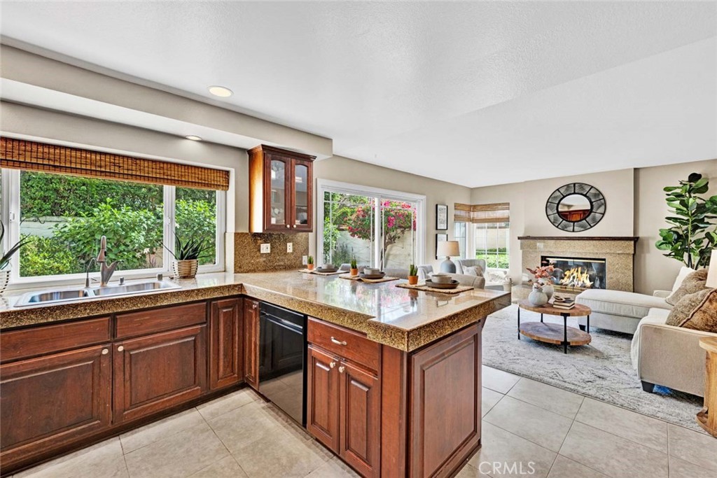 2489 Via Castillo Tustin, CA 92782 - Photo 8 of 30 a view of a kitchen counter top space with a sink and dishwasher a oven with large countertops