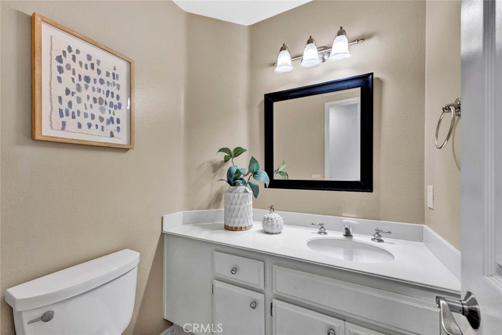 2489 Via Castillo Tustin, CA 92782 - Photo 10 of 30 a bathroom with a toilet sink and mirror