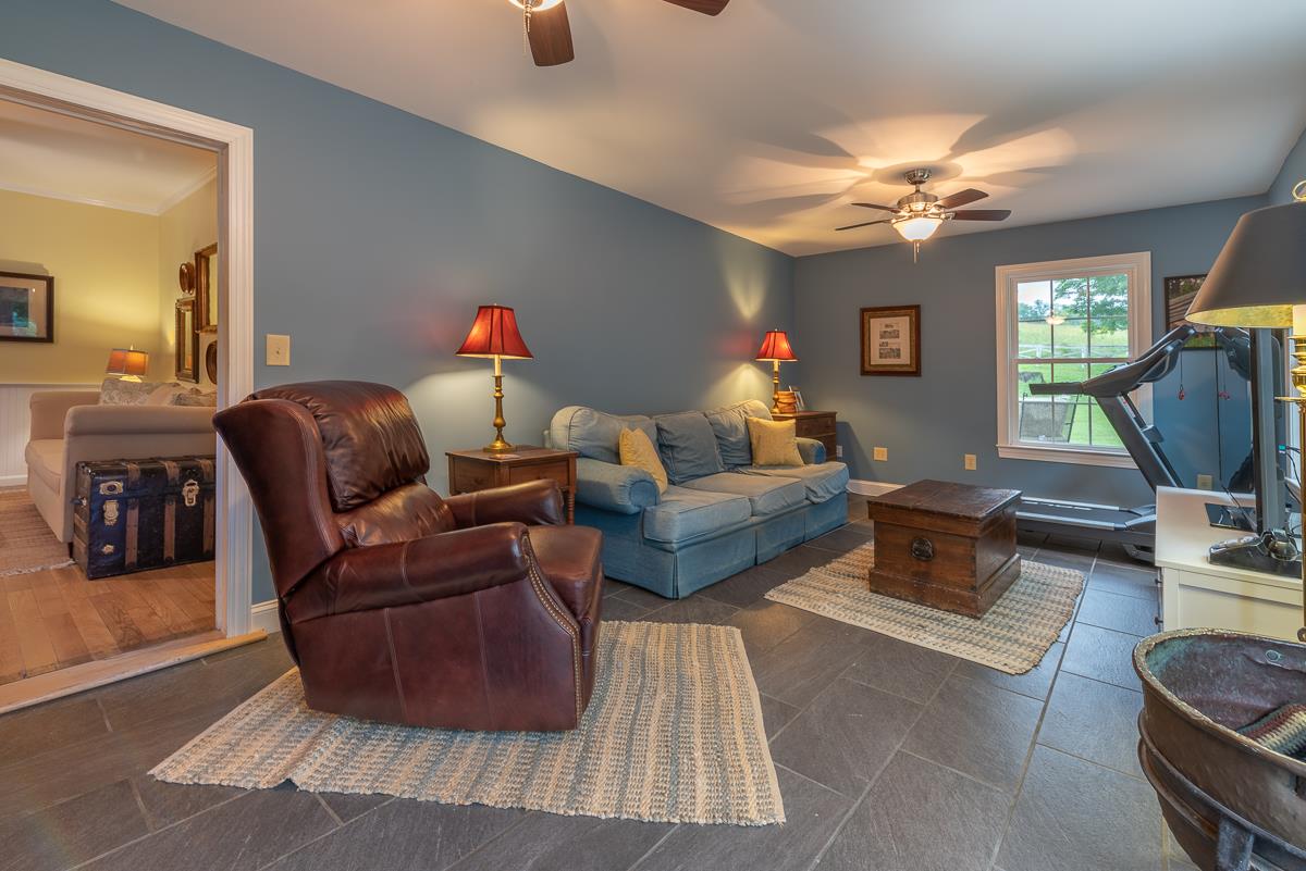 227 Middlebrook Road Staunton, VA 24401 - Photo 32 of 50 a living room with furniture a chandelier and a flat screen tv