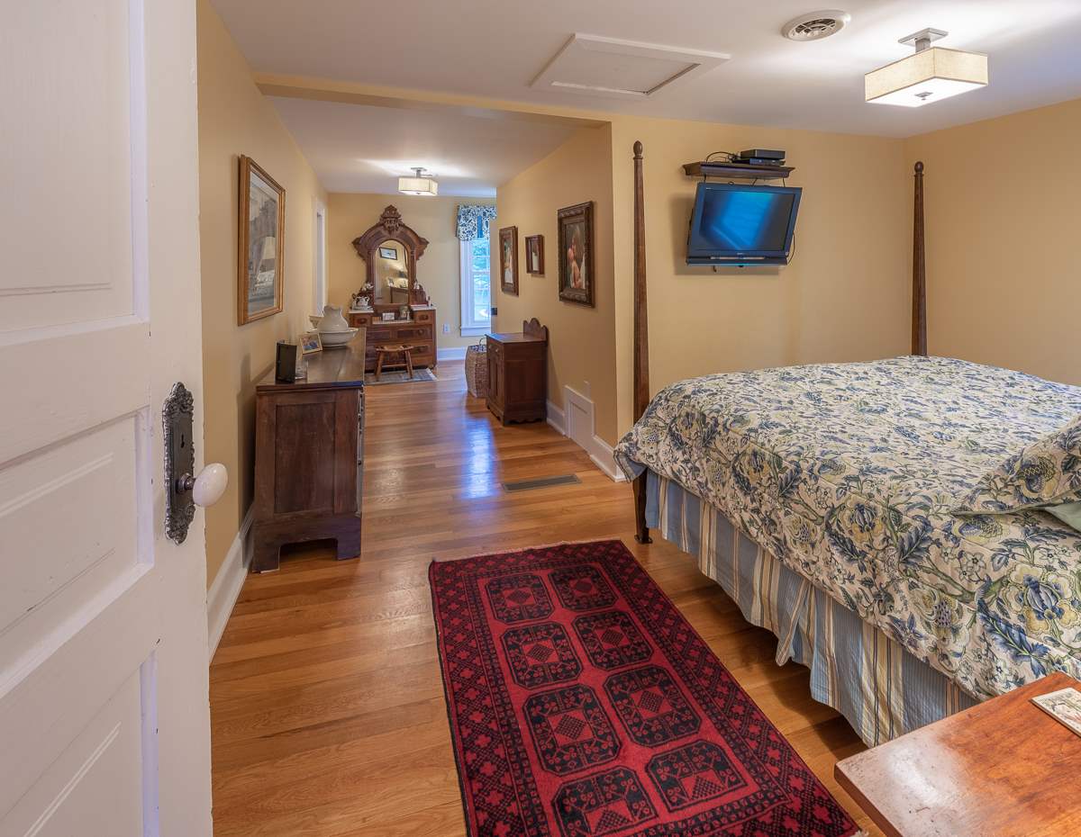 227 Middlebrook Road Staunton, VA 24401 - Photo 36 of 50 a hallway with wooden floor and a chandelier