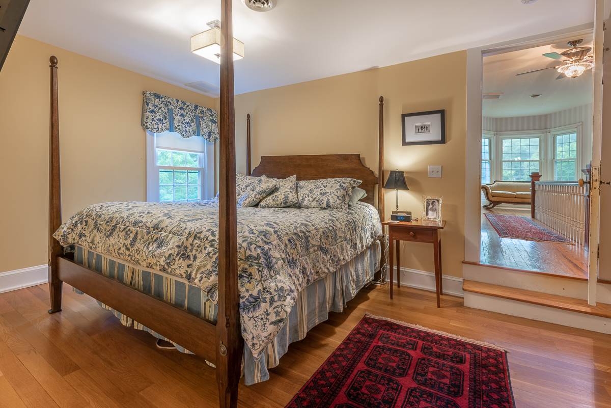 227 Middlebrook Road Staunton, VA 24401 - Photo 37 of 50 a bedroom with a bed and wooden floor