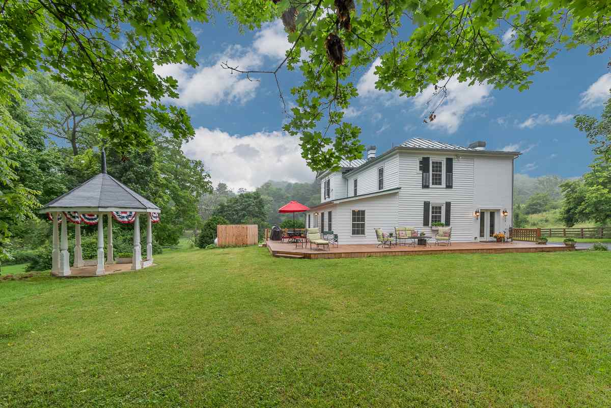 227 Middlebrook Road Staunton, VA 24401 - Photo 9 of 50 a front view of a house with a garden and trees