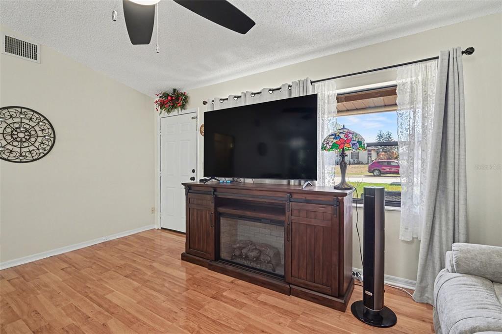 12435 Orangewood Circle Tavares, FL 32778 - Photo 9 of 30 a living room with furniture and a flat screen tv