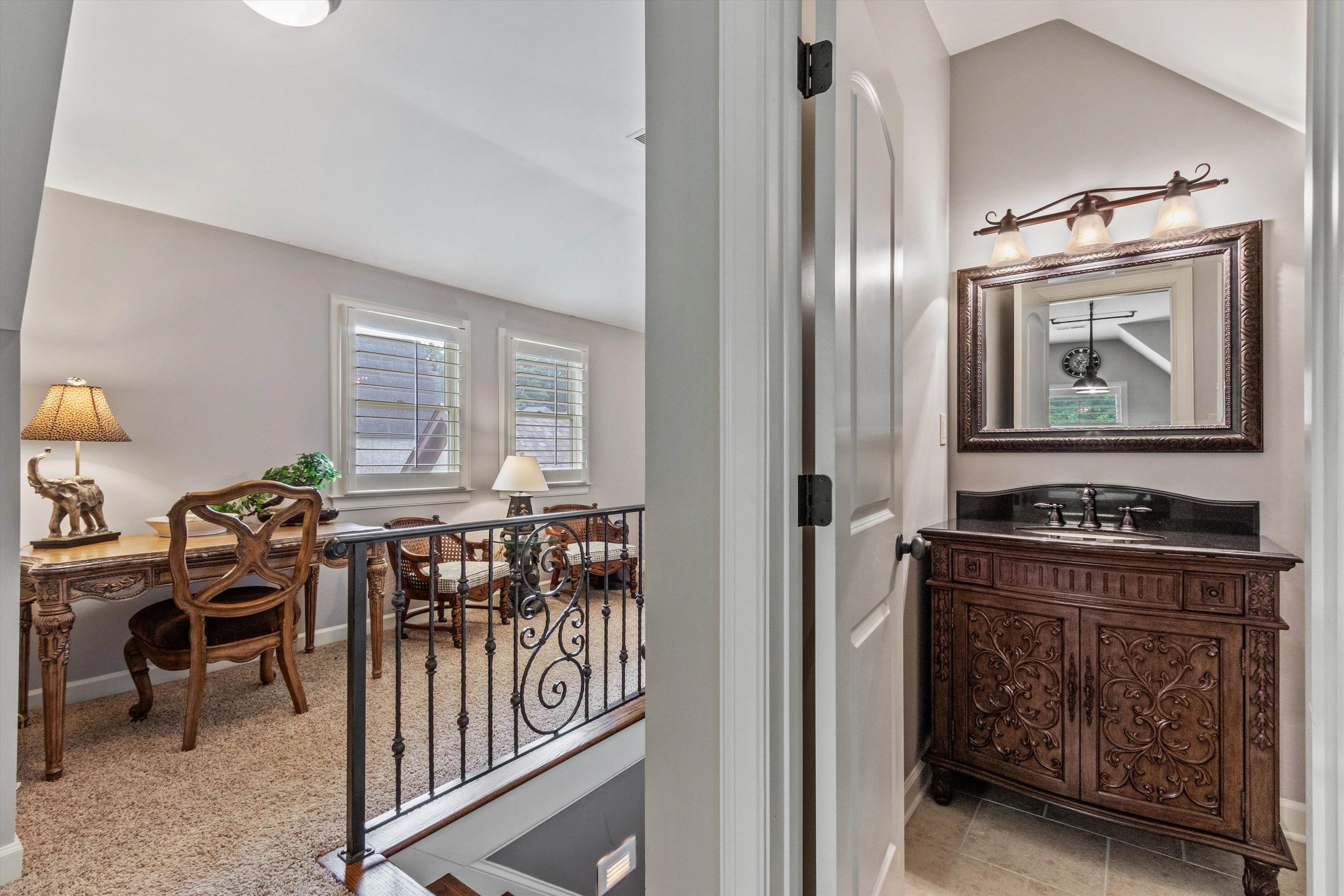 150 Ridgecrest Drive Arlington, TN 38002 - Photo 29 of 40 Open loft area featuring two windows with plantation shutters, carpeted flooring, and a decorative wrought iron railing overlooking the space below