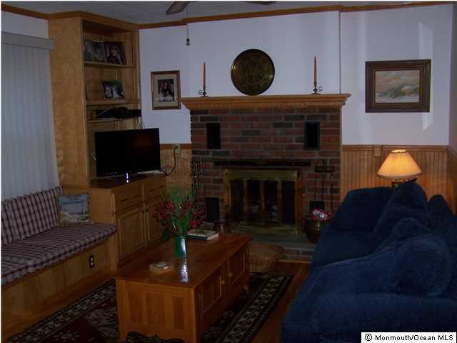 657 Thoroughfare Road Brick, NJ 08724 - Photo 11 of 23 a living room with furniture and a fireplace
